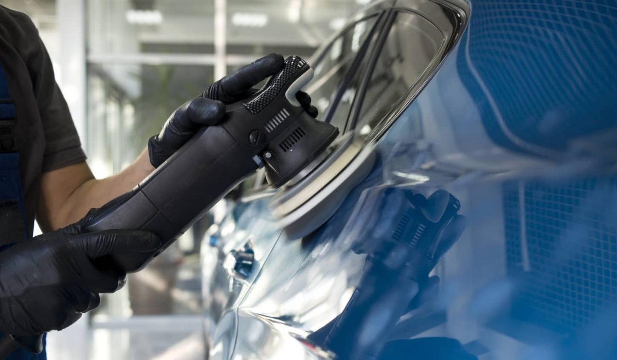 An image of a mechanic making cosmetic repairs on a car